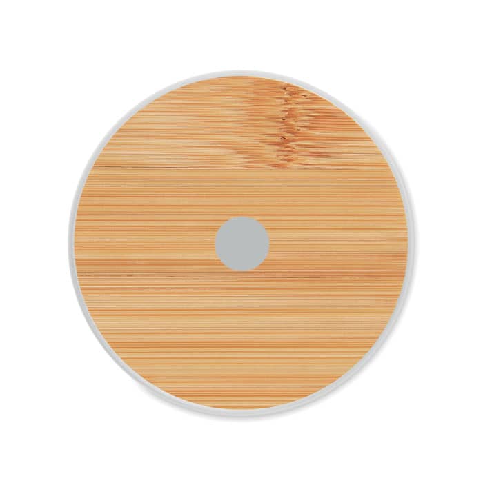 A round bamboo drink coaster with a central hole, featuring a smooth natural wood finish and a white border.