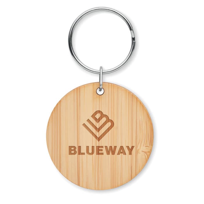 A keyring made of bamboo with a circular shape and a logo engraved on it, featuring a metallic attachment.