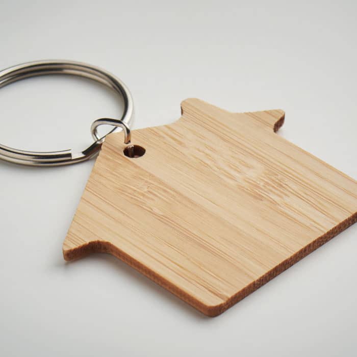 A keyring featuring a bamboo house-shaped tag with a metal ring attachment.