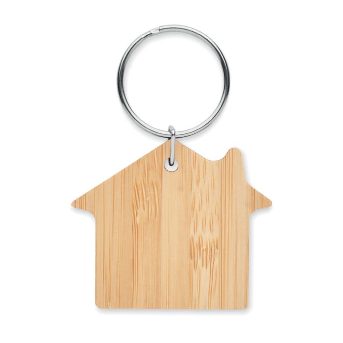 A wooden keyring shaped like a house, attached to a metal ring. The keyring has a natural beige finish.