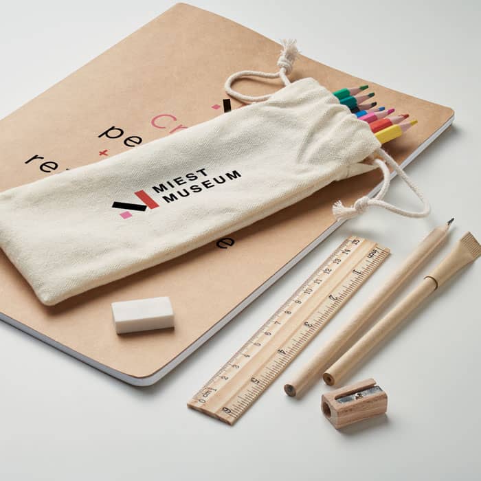 A collection featuring a cream pencil case with multicoloured pencils, a notebook, a ruler, an eraser, and a sharpener.