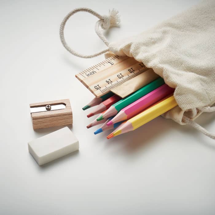 A canvas pouch containing coloured pencils, a ruler, a sharpener, and an eraser, all on a light surface.