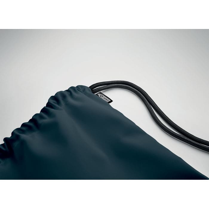 A drawstring bag in dark navy with a textured finish and adjustable cord. Features a logo on the side.