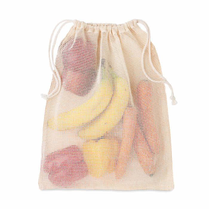 A mesh produce bag containing a variety of fruits and vegetables, including bananas, carrots, and strawberries.