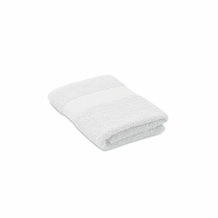 A folded white towel with a textured surface and a smooth band across the middle.
