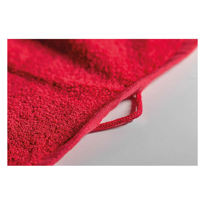 A red terry cloth product with a looped edge detail for hanging or storage.