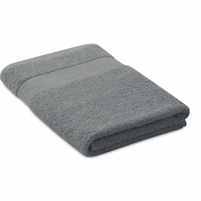 A grey towel folded neatly, featuring a textured stripe detail. It has a soft, plush appearance.