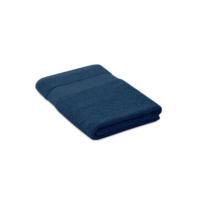 A towel folded neatly in a deep navy blue colour, featuring a textured band. It has a simple design with no visible logos.