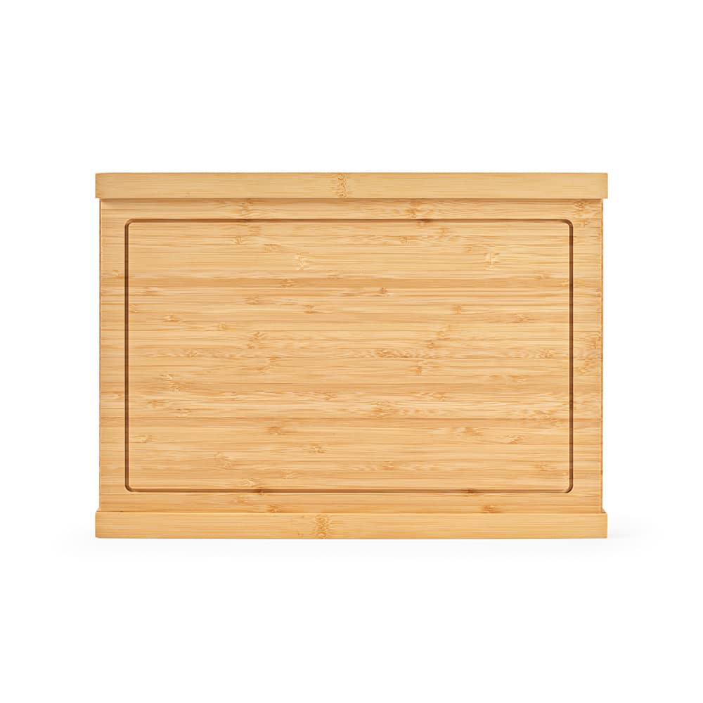 A bamboo cutting board with a smooth surface and a recessed area, featuring a simple design and light brown hues.