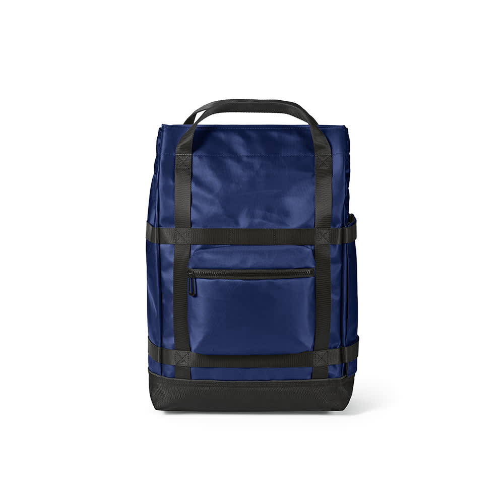 A navy blue Wellington Backpack with a magnetic closing, featuring straps and a front pocket, fits a 17" laptop.