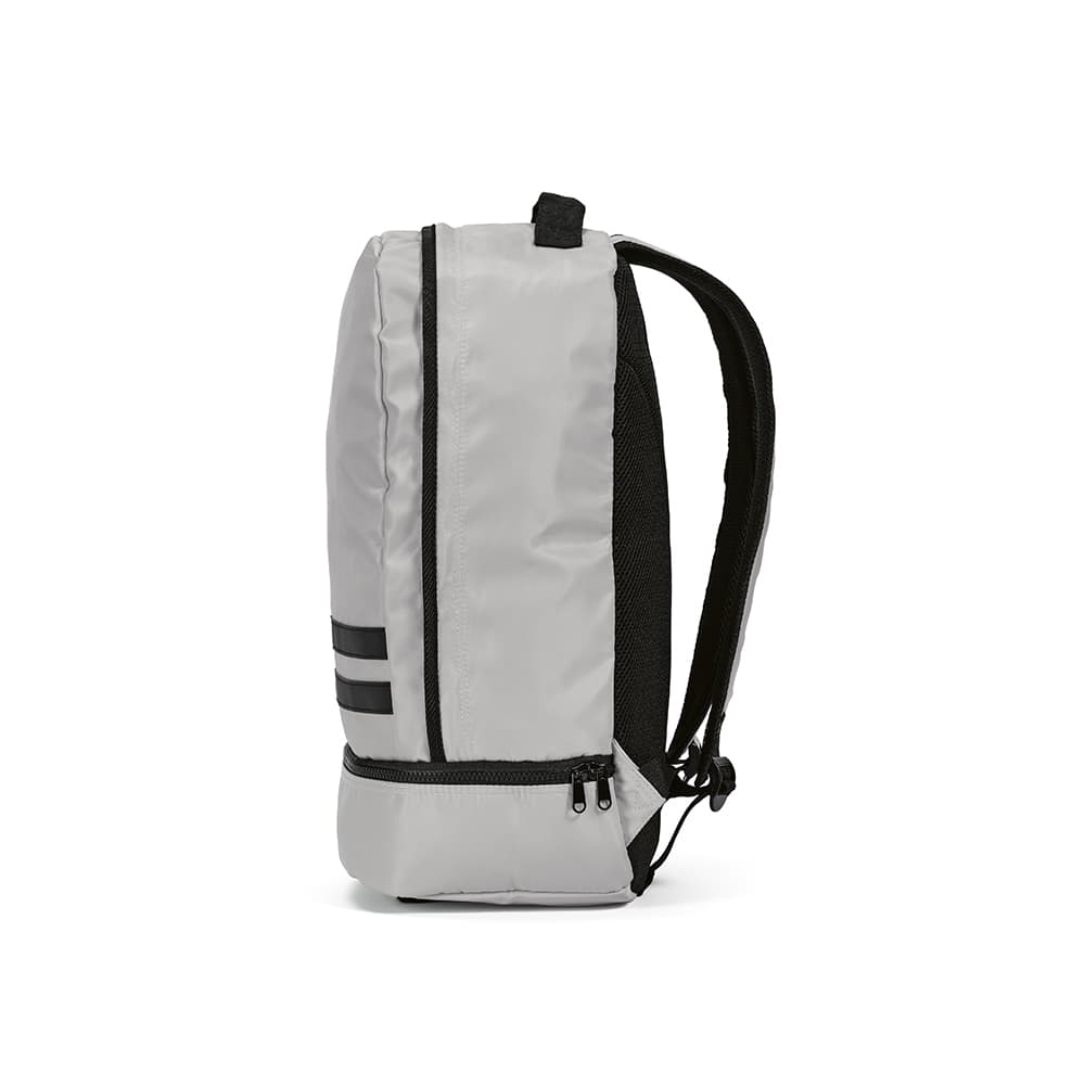 A grey backpack with black reflective front strips and padded shoulder straps. It features a zipped compartment at the base.