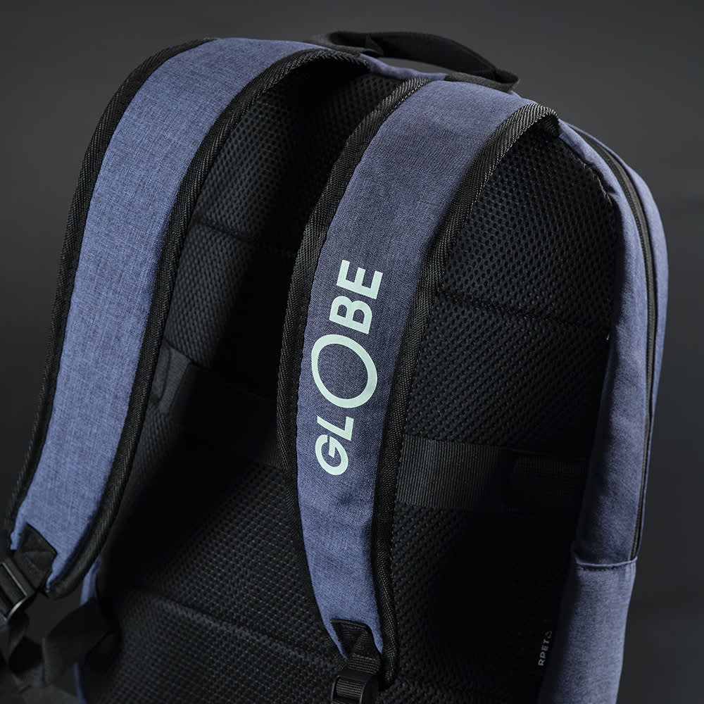 A blue and black backpack with padded shoulder straps and a logo on the side.