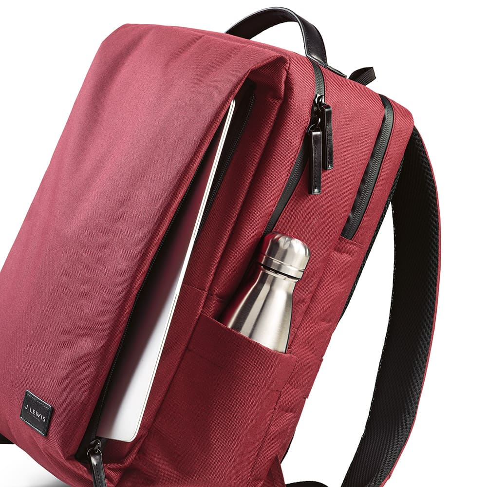 A maroon backpack with waterproof zippers and a side pocket for a drink bottle, designed to fit a 17" laptop.