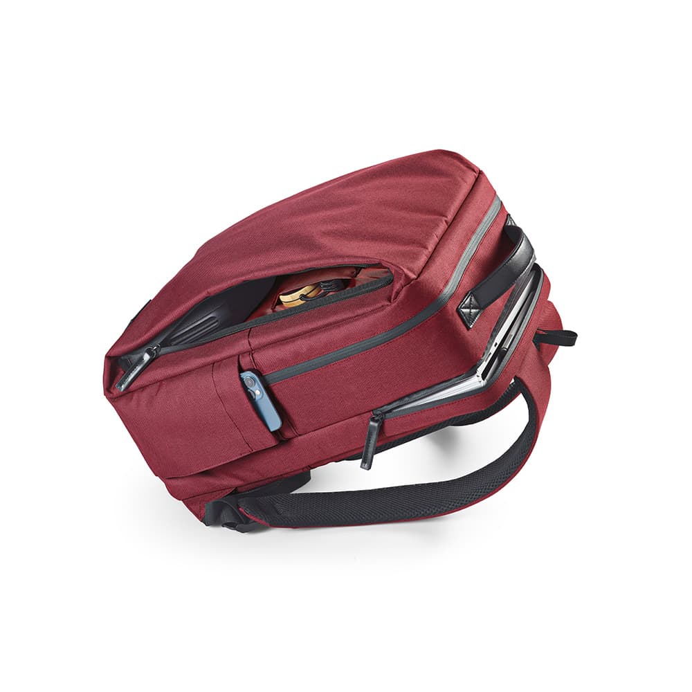 A red Oslo Backpack with waterproof zippers, designed to fit a 17" laptop, features multiple compartments and a logo.