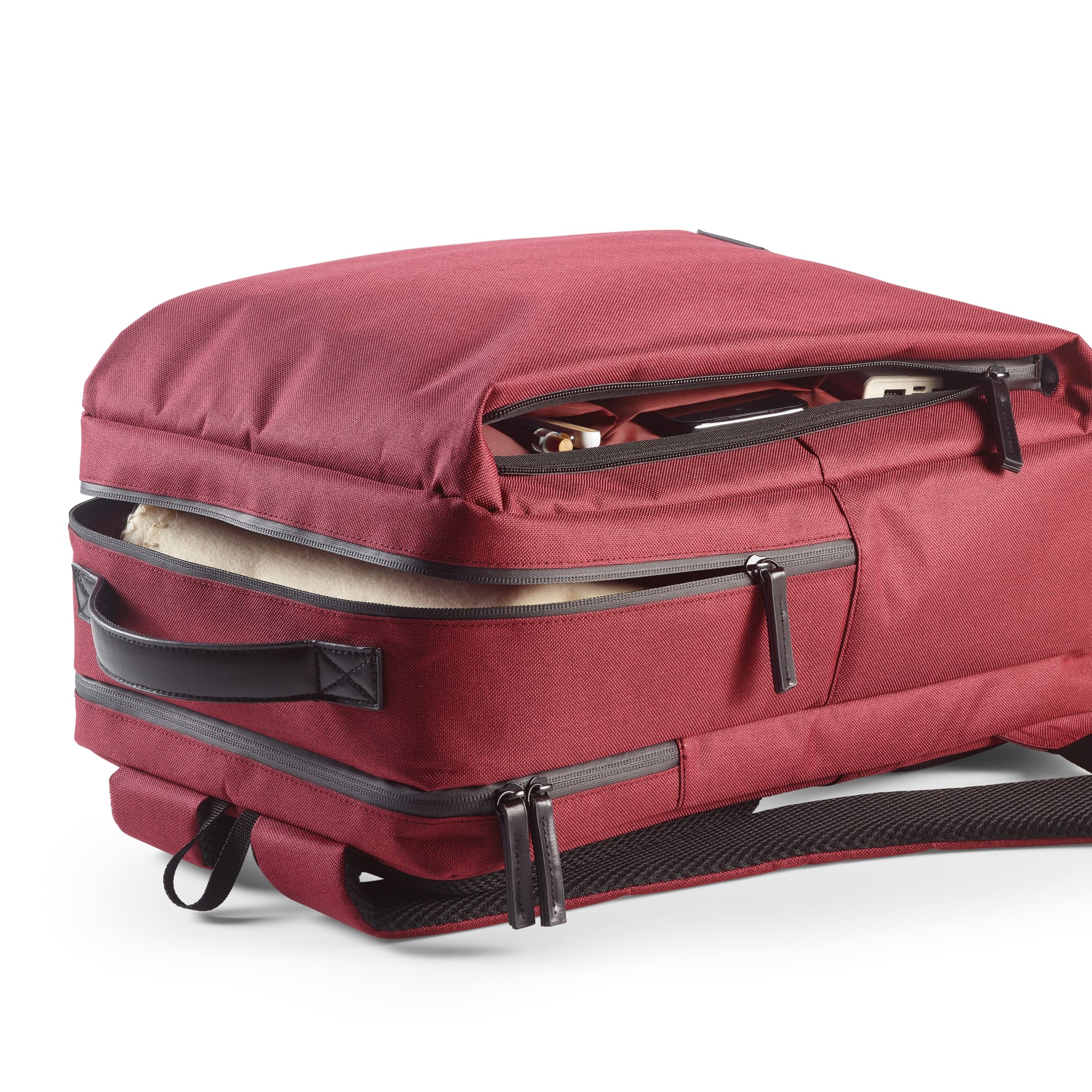 A maroon Oslo backpack with waterproof zippers, featuring compartments and space for a 17" laptop. Includes a logo.