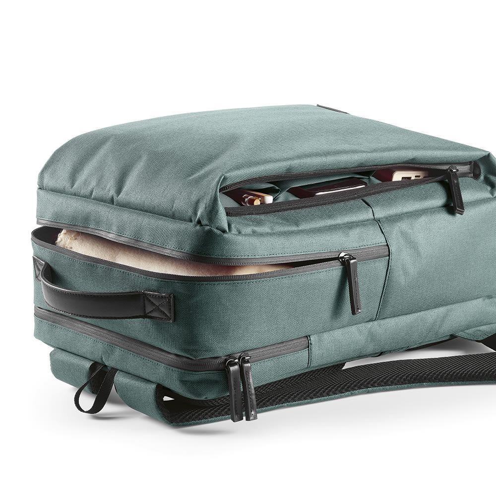 A green Oslo Backpack with waterproof zippers, featuring compartments for a 17" laptop and additional storage.