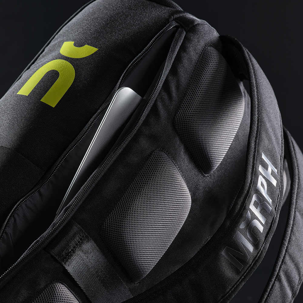 A black backpack with a front pocket, designed to fit a 15.6" laptop, features padded sections and a logo.