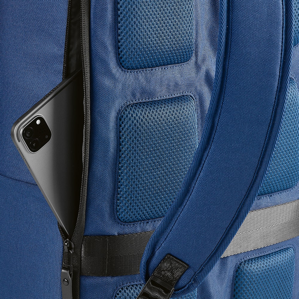 A navy blue backpack with a front pocket, featuring a phone partially visible inside the side zip.