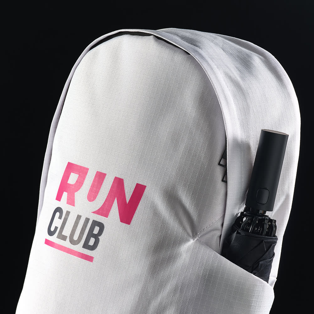 A white backpack with a rounded top, featuring a logo and an umbrella tucked into the side.