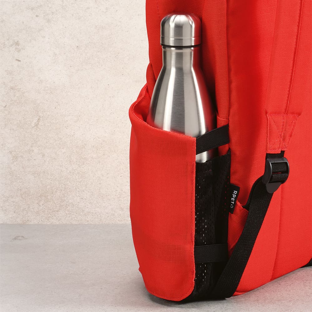 A red backpack with a stainless steel drink bottle in a side pocket, featuring a mesh detail.