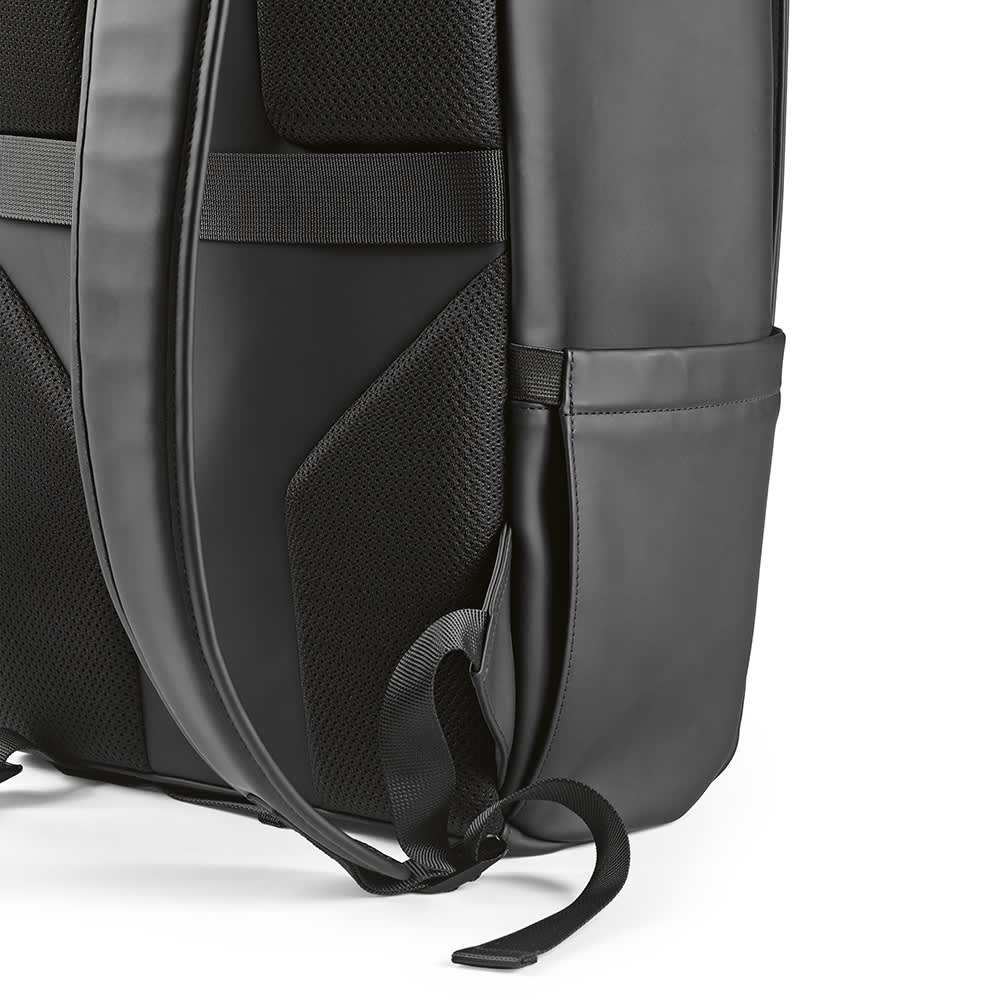 A black backpack featuring padded straps, multiple pockets, and a sleek design, with a logo on the surface.
