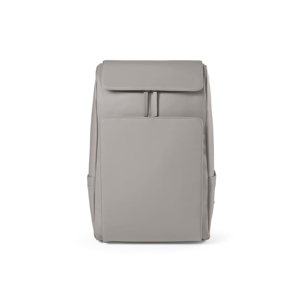 A grey backpack with a zipped top compartment and a large front pocket. Features side pockets and has a logo.