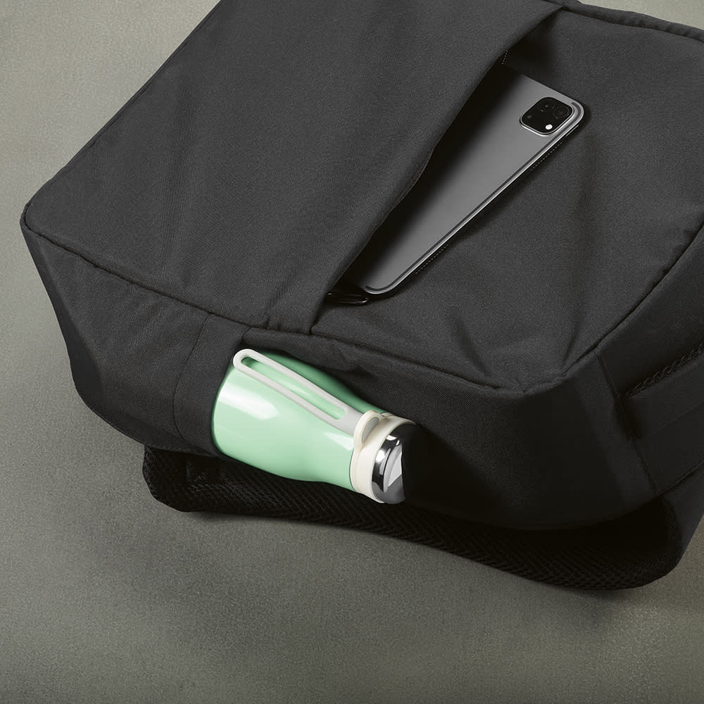 A black backpack featuring a front pocket, holding a green drink bottle and a smartphone on top.