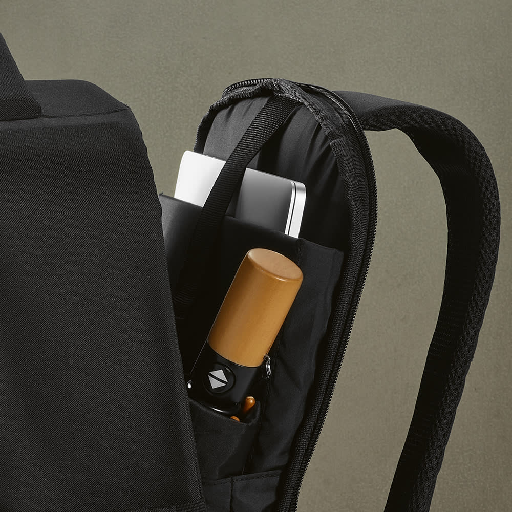 A black backpack with a front pocket, holding a drink bottle and a laptop in a protective sleeve.