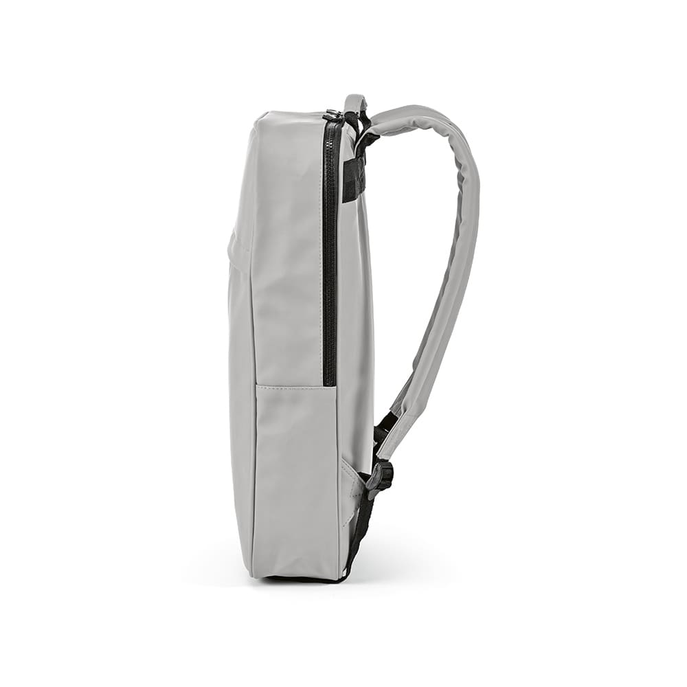 A grey backpack with a slim design, featuring a zippered pocket and a single padded strap.