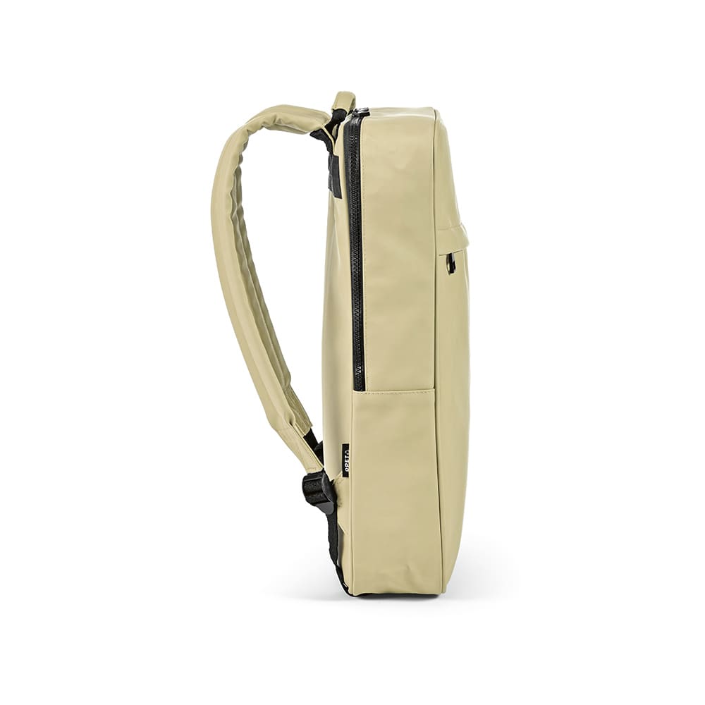 A side view of a beige Amsterdam backpack with space for a 17" laptop and a logo. Features adjustable straps.