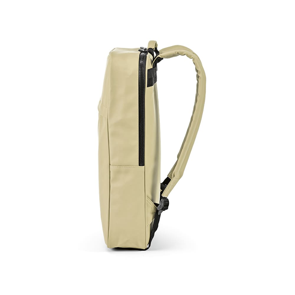 A beige Amsterdam Backpack made from rPU and rPET, featuring a single shoulder strap and a zippered compartment.