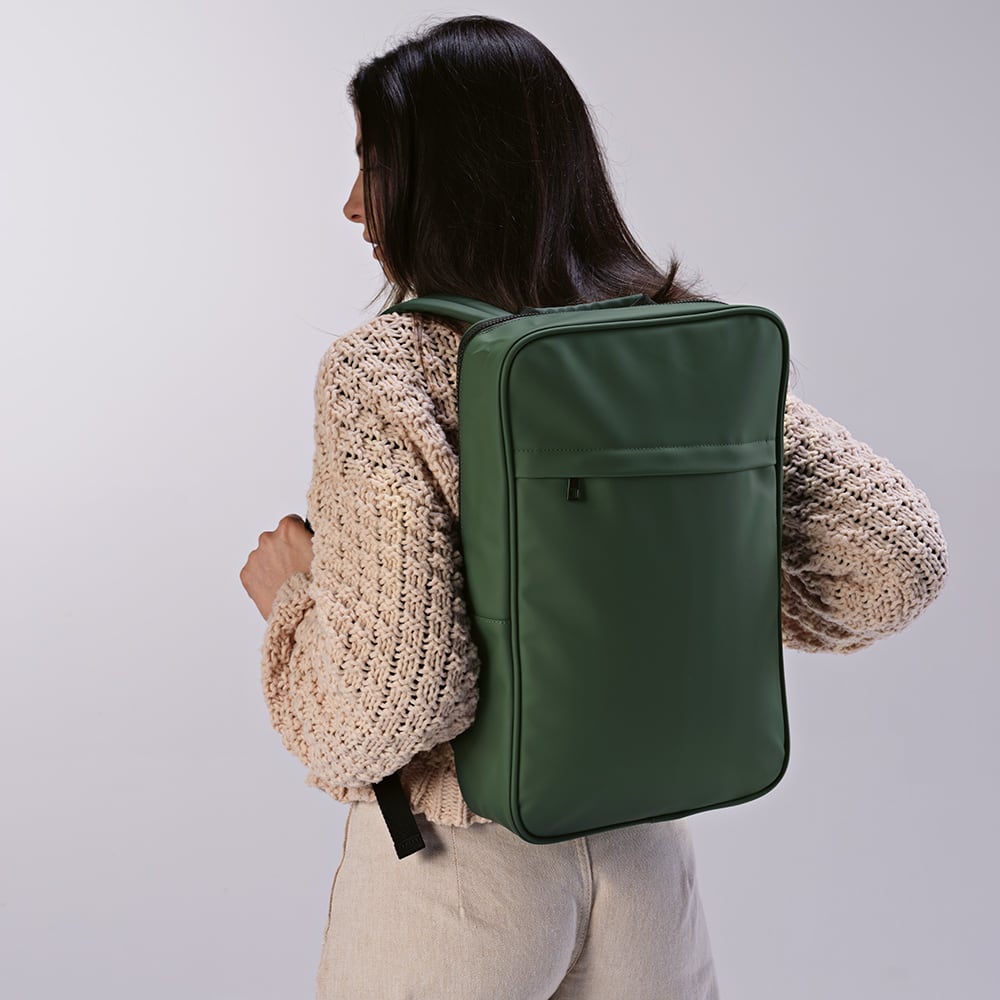 A green backpack with a sleek design, worn on the back, featuring a logo. Suitable for a 17" laptop.