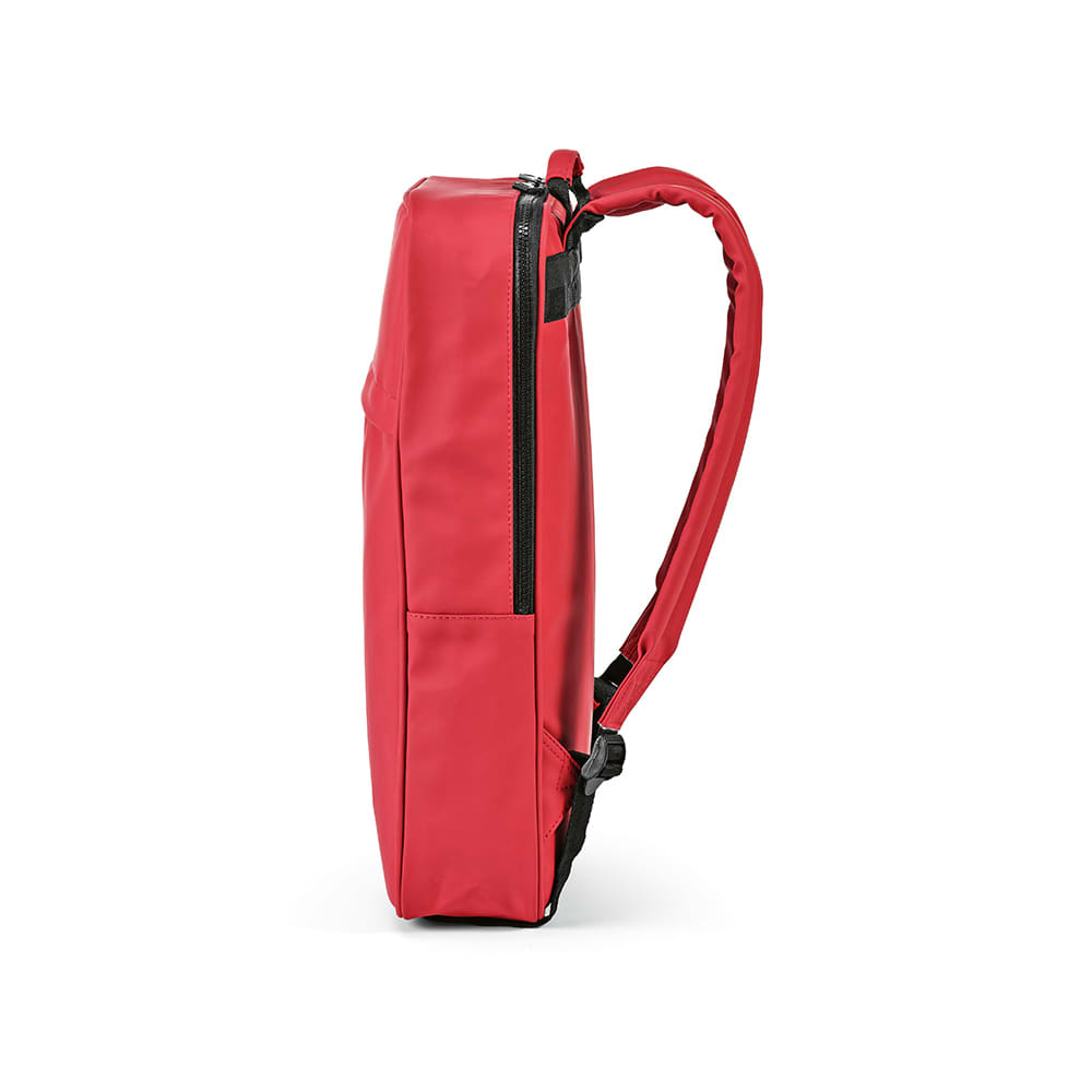 A red backpack with a slim profile, featuring a side zip and a single strap. It includes branding on the surface.