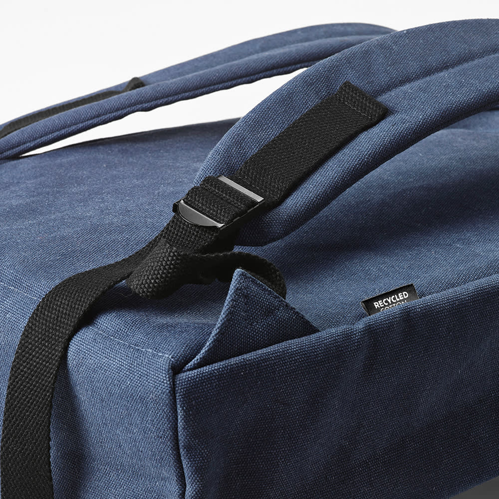 A navy blue backpack with a hook closure and adjustable straps, featuring a recycled materials label.