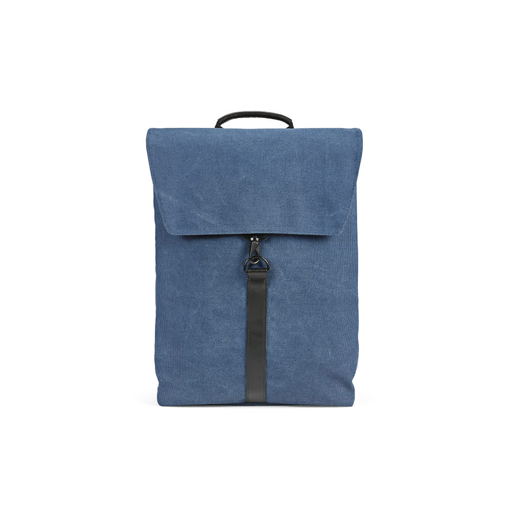 A blue backpack made of cotton material with a hook closure and a top handle, designed to fit a 17" laptop.