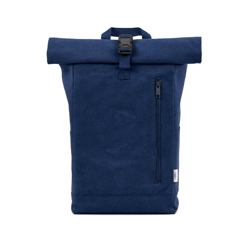 A navy blue roll-top backpack with a buckle closure and a side zip pocket. The design features a branding label.