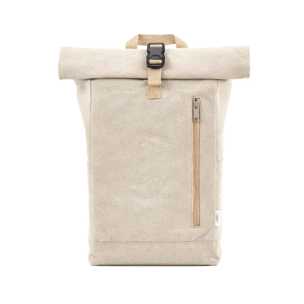 A roll-top backpack in sandy beige, featuring a buckle closure and a side zip pocket. Includes a logo.