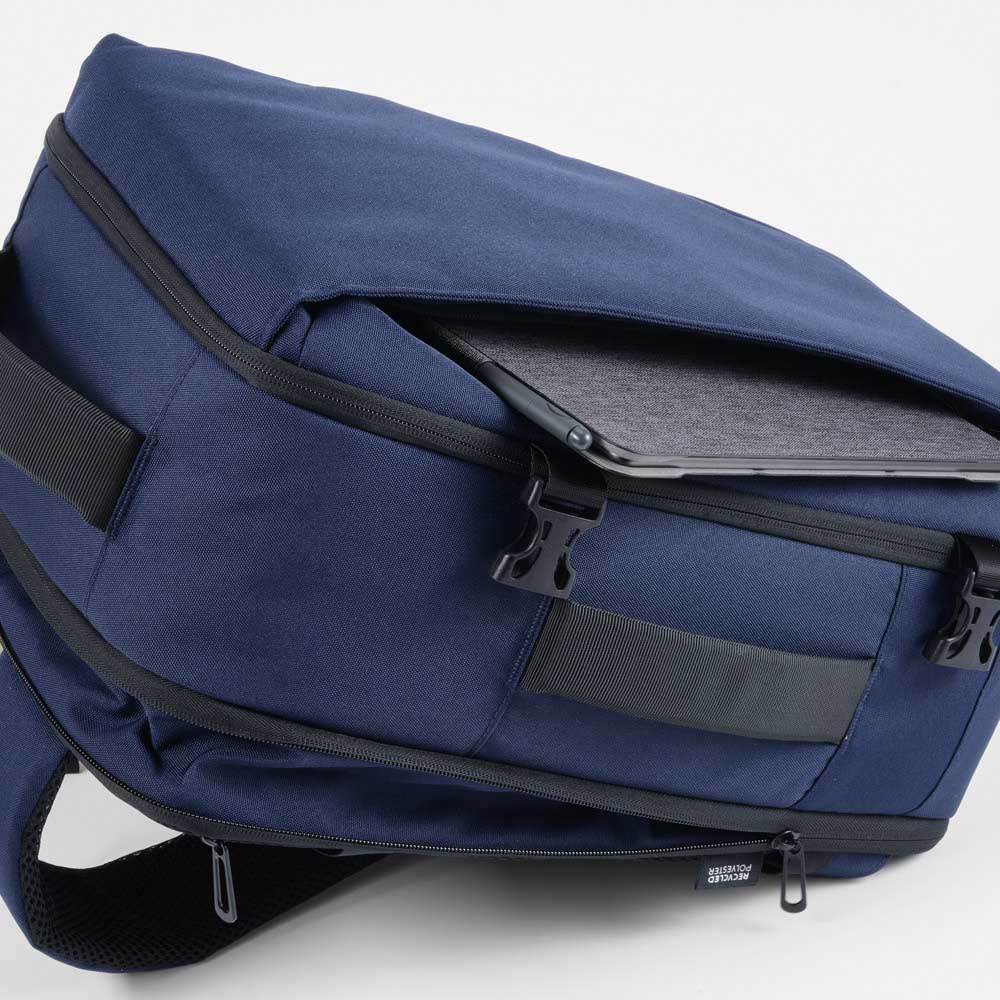 A navy blue backpack with a compartment for a laptop and zippers, featuring a logo. Made from recycled materials.