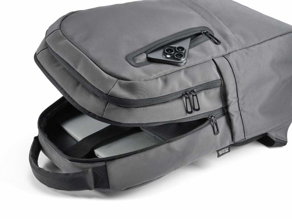 A grey backpack with a spacious interior, designed to fit a 17" laptop, featuring a zippered pocket and a logo.