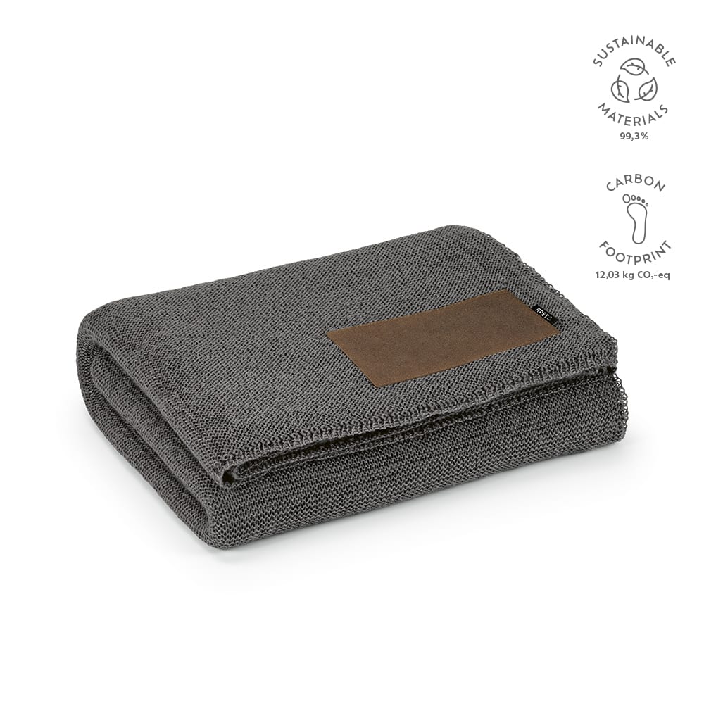 A grey blanket made from rPET and wool blend, featuring a customisable patch and a logo.