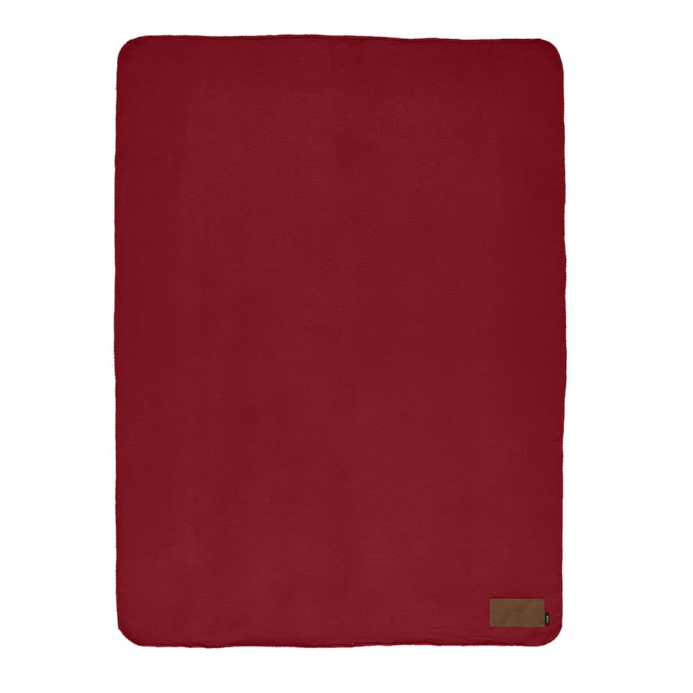 A red rPET blanket with a customisable patch and a logo on a corner.