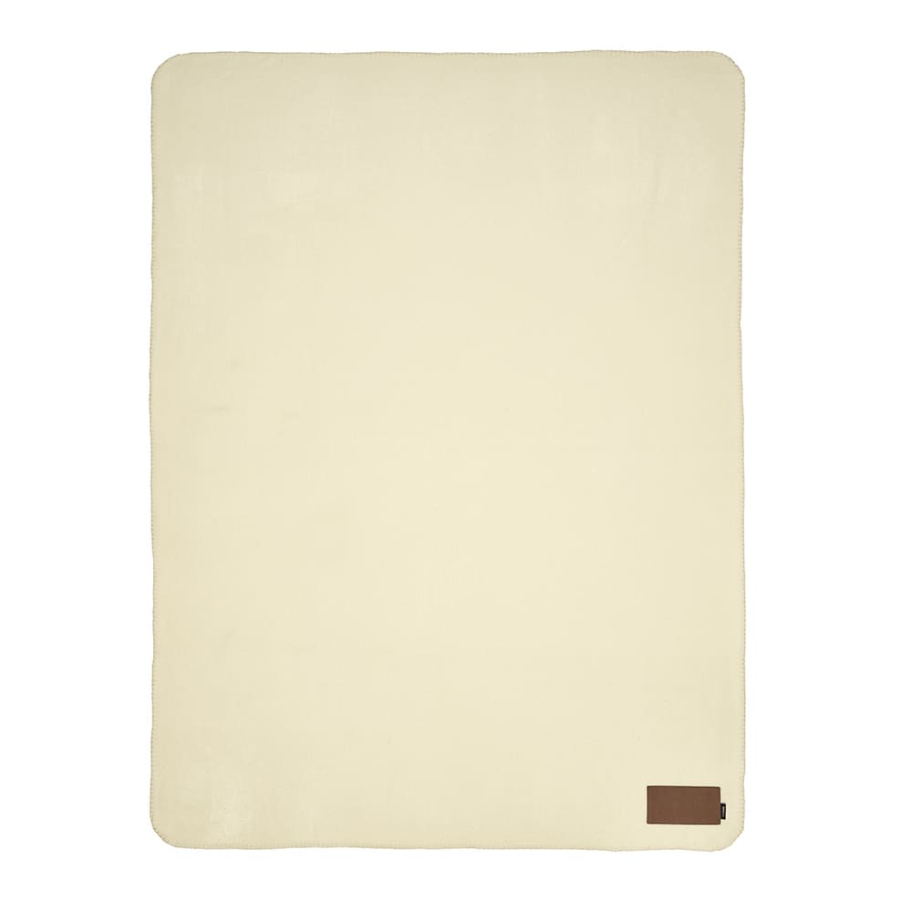 A cream blanket made from rPET, featuring a customisable patch and a small logo on one corner.