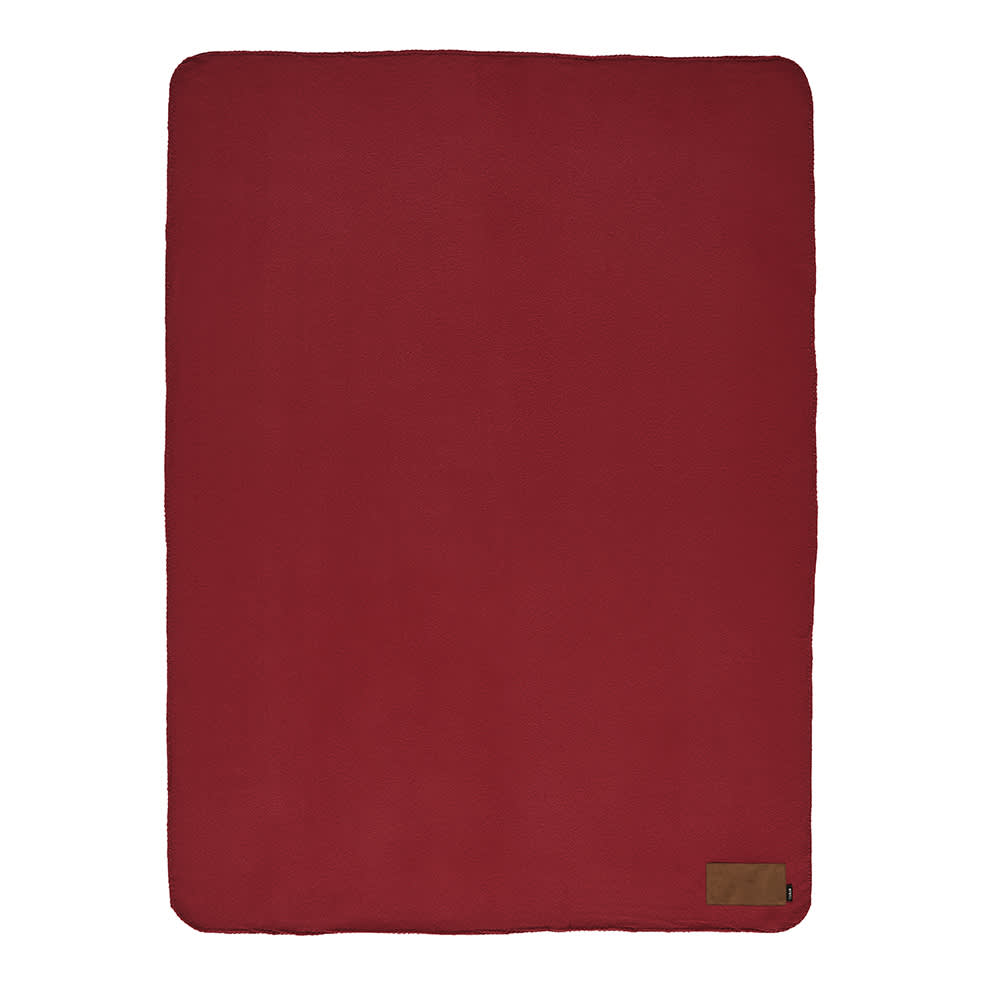 A red blanket made from rPET material, featuring a customisable patch and a small logo at the bottom.