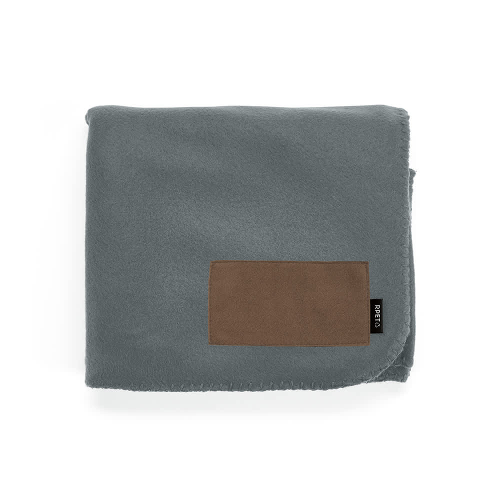 A grey fleece blanket with a brown customisable patch and a logo tag on the side.