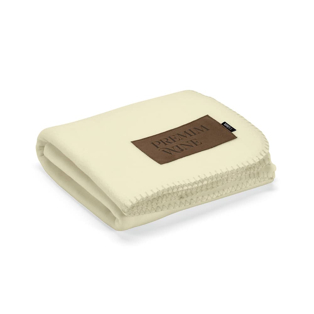 A cream-coloured blanket made from rPET, featuring a customisable patch and a sewn edge detail.