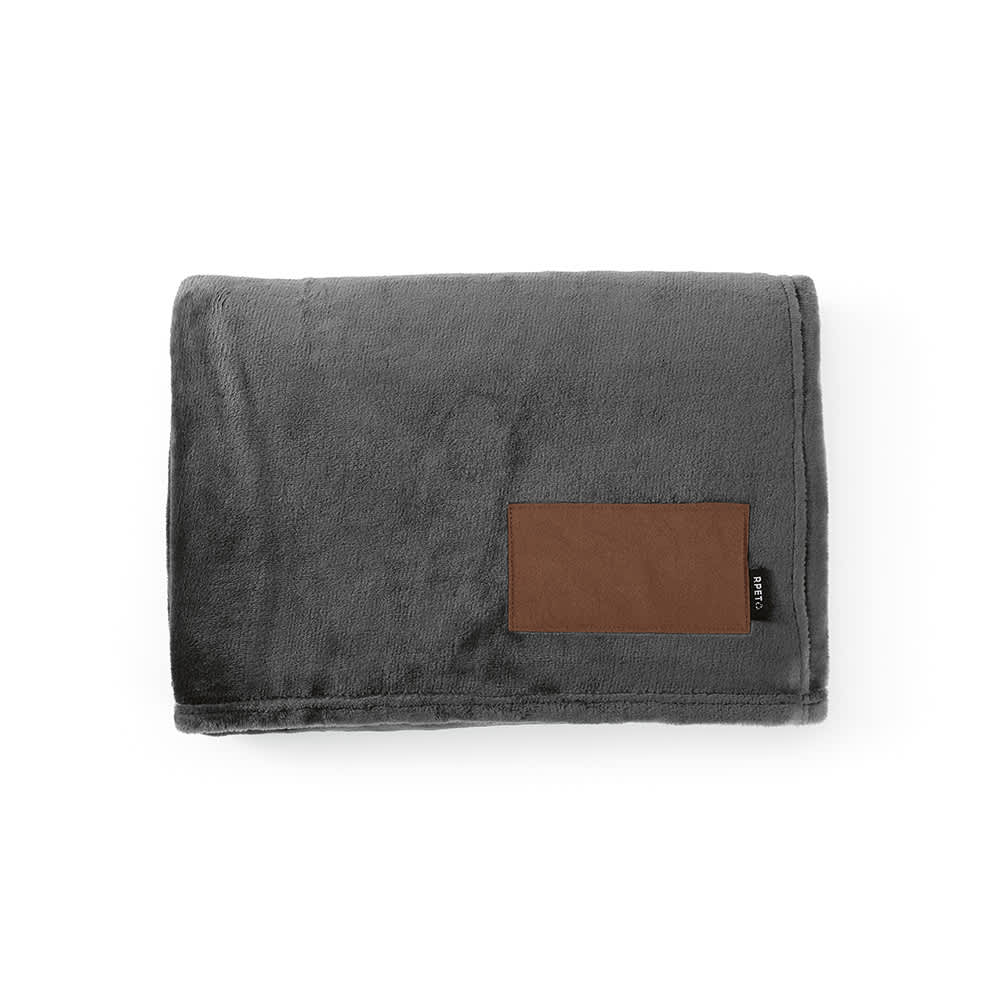 A grey fleece blanket with a brown customisable patch on one side, featuring a small logo.
