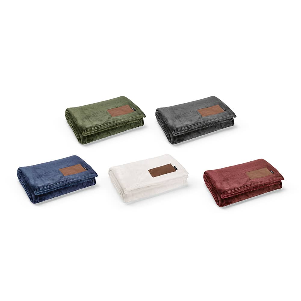 A collection of five folded blankets in green, navy, grey, white, and burgundy, each featuring a customisable patch.