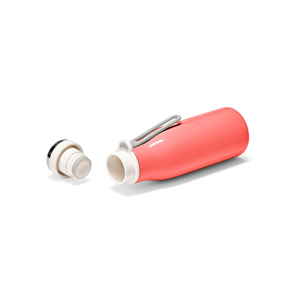 A drink bottle in coral with a white lid, featuring a handle and a leakproof design, next to its removable lid.