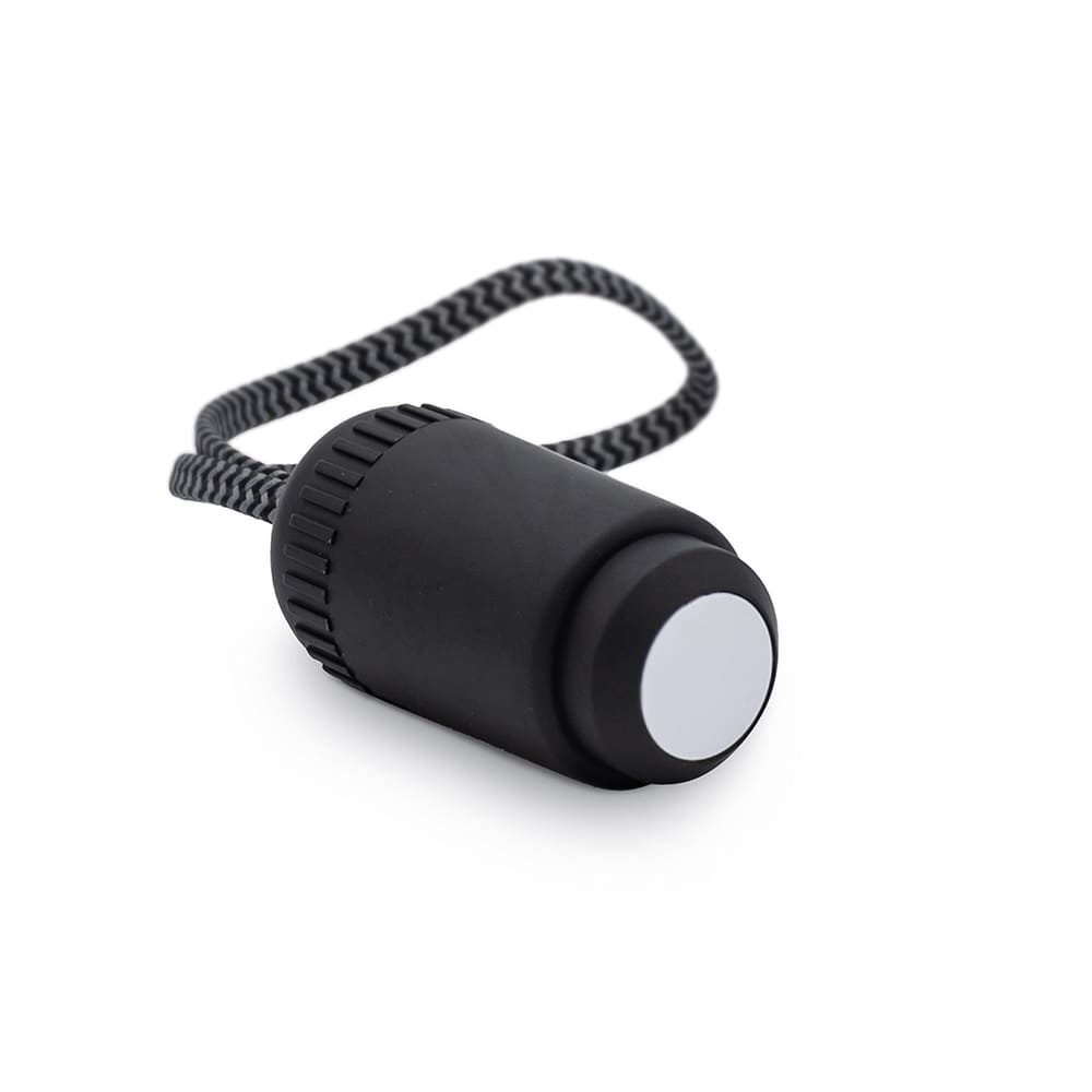 A black accessory with a textured surface and a braided strap, featuring a circular button at one end.