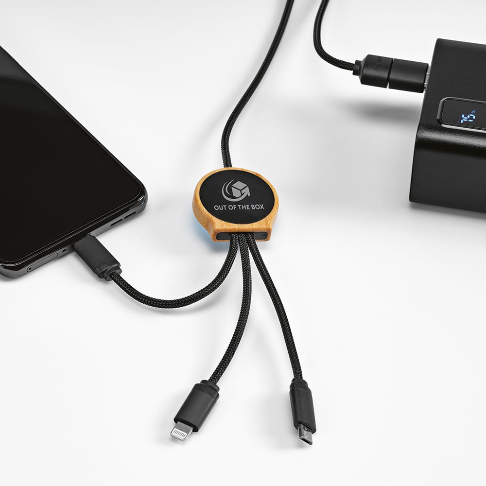 A 5-in-1 charging cable with a bamboo connector, featuring a backlit logo, connecting a phone to a power source.
